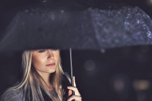 A woman is standing in the rain San Diego-1000x667